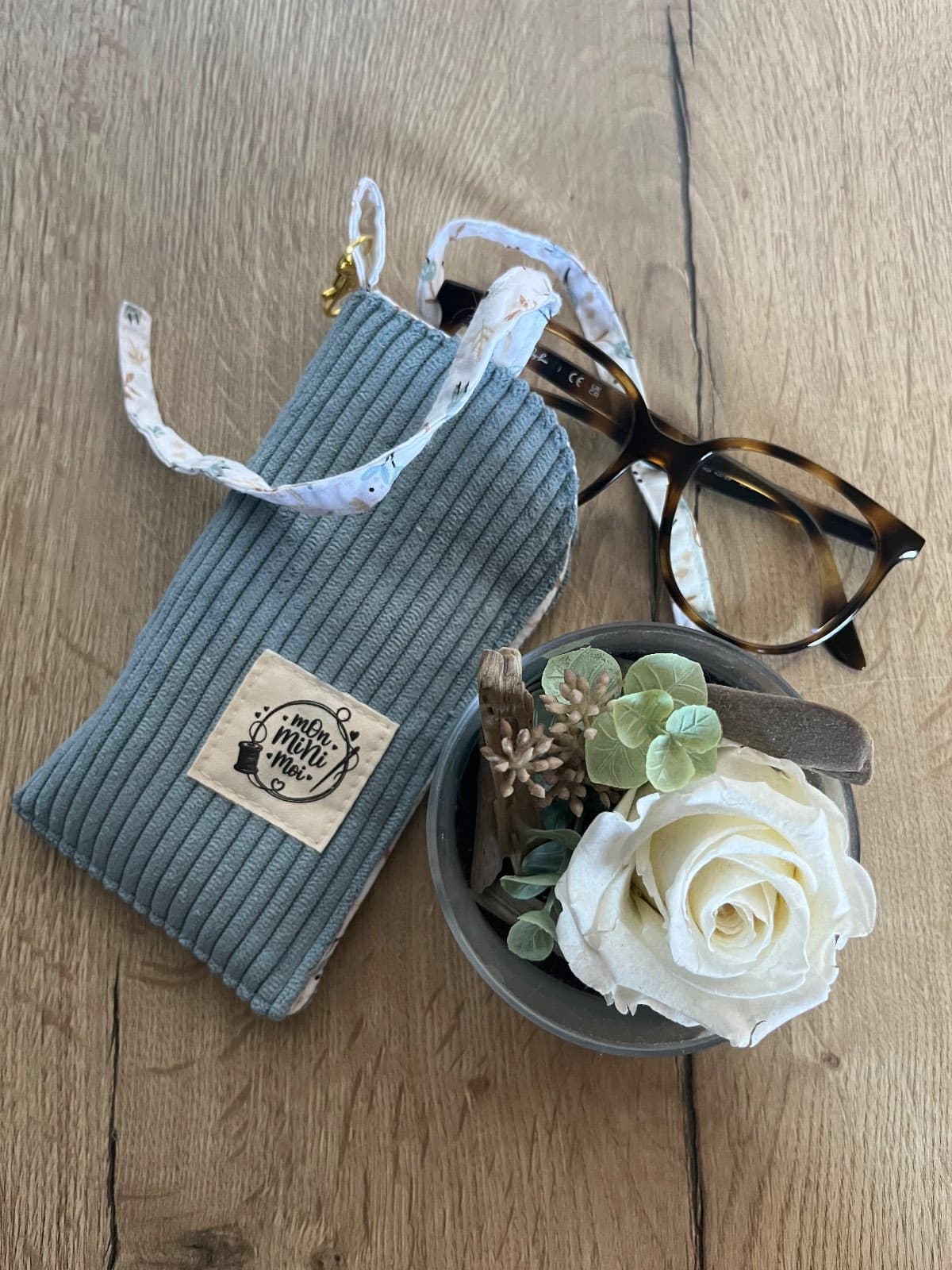 Détail de l'étui à lunettes artisanal en velours côtelé bleu jean et tissu à fleurs.